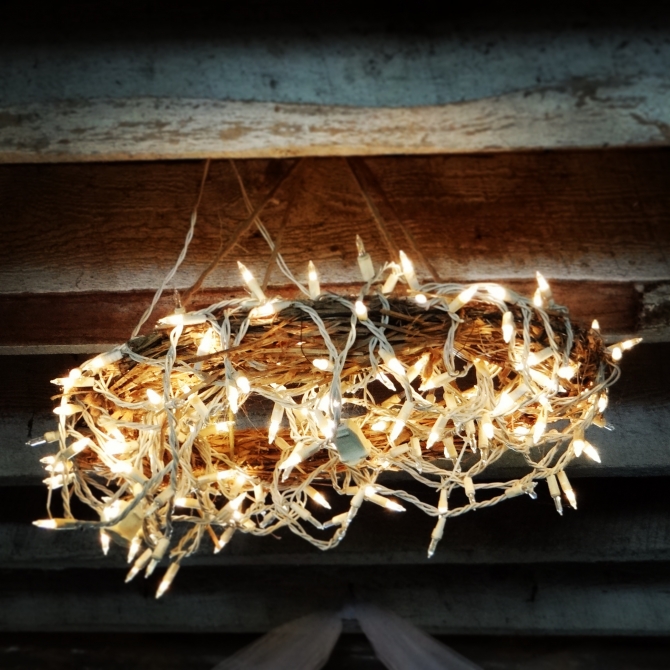 Straw wreaths with mini lights in the barn for the #wedding